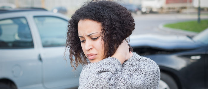 woman holding neck after car accident