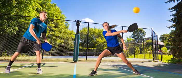 woman and man playing pickleball